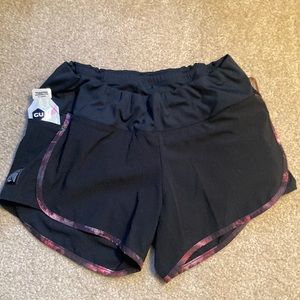 Oiselle Track Star shorts, black with fall foliage trim. Size 8.